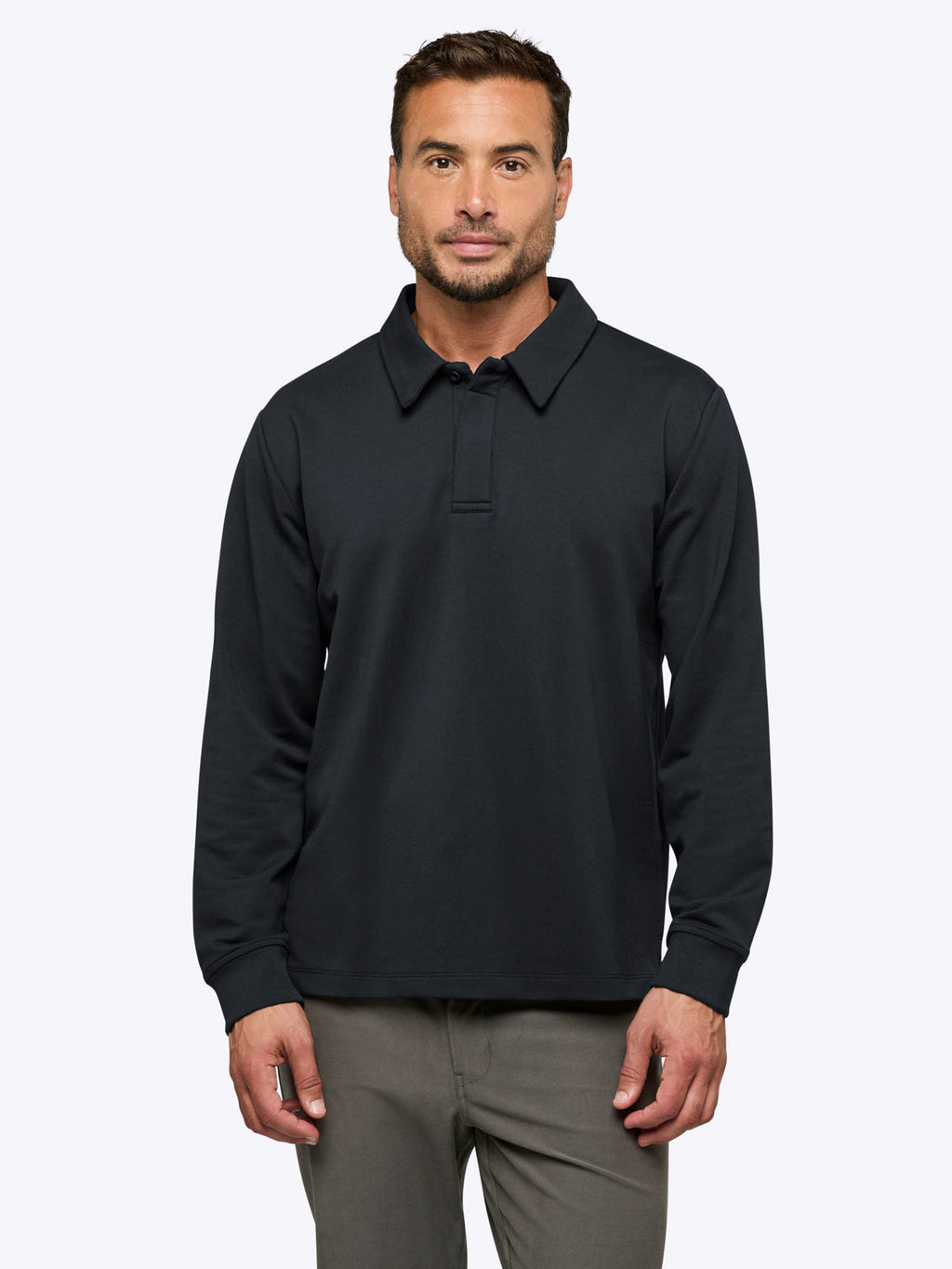 Man wearing a dark dark blue long-sleeve polo shirt on a white background